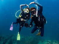 Scuba divers doing a safety stop on a Koh Tao reef